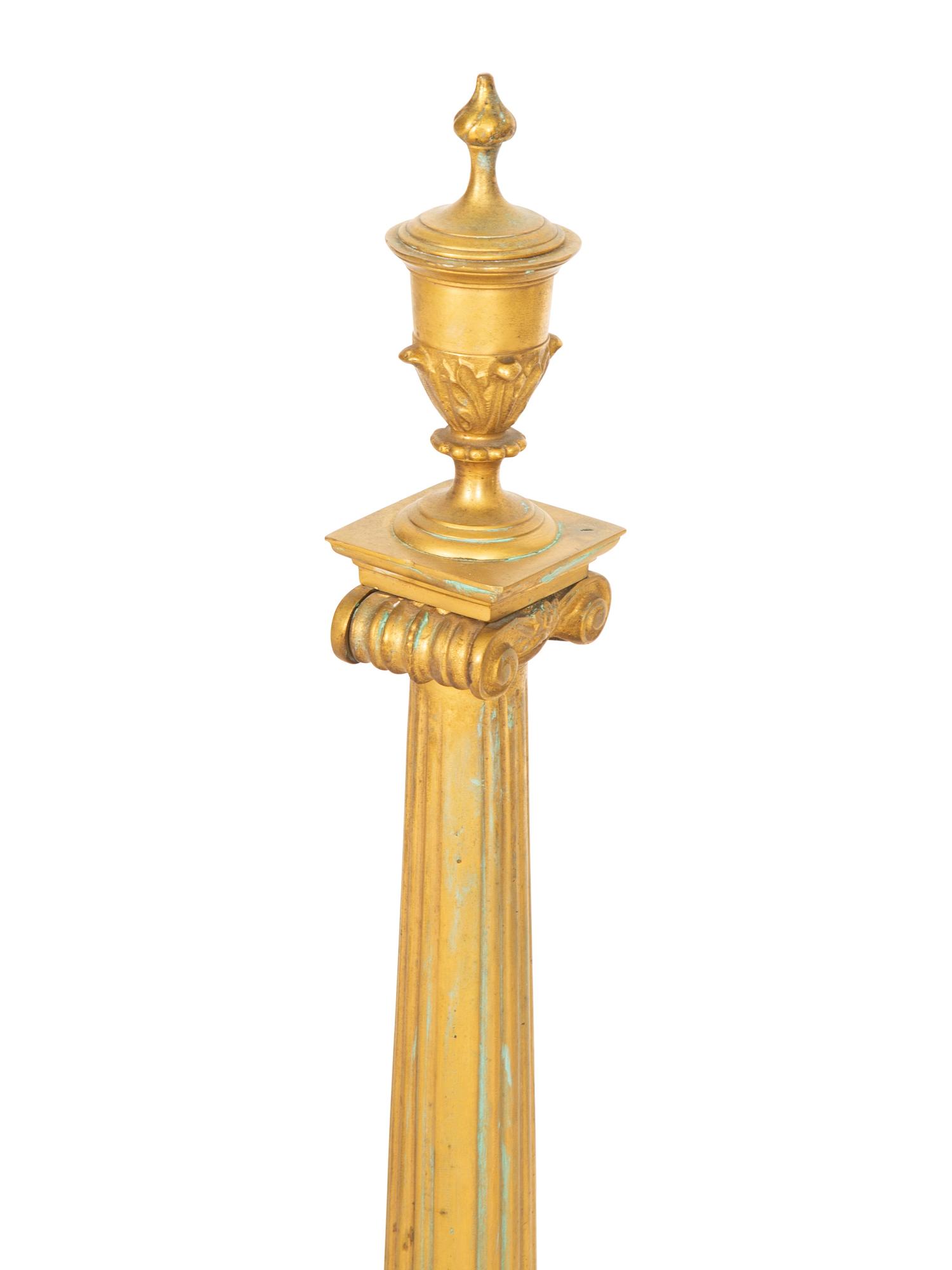 A Pair of Continental Gilt Bronze Chenets and an Associated Fire Screen