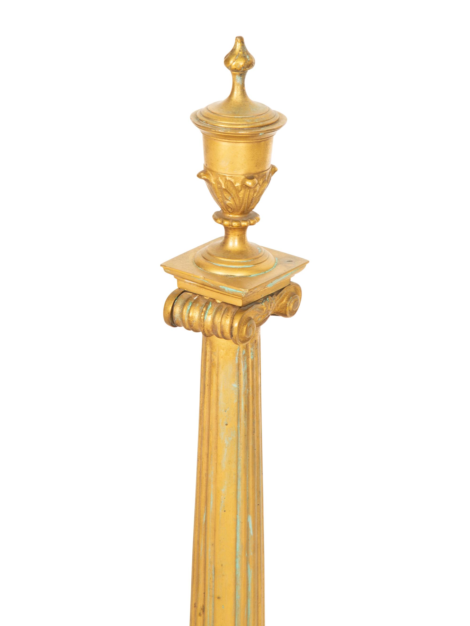 A Pair of Continental Gilt Bronze Chenets and an Associated Fire Screen