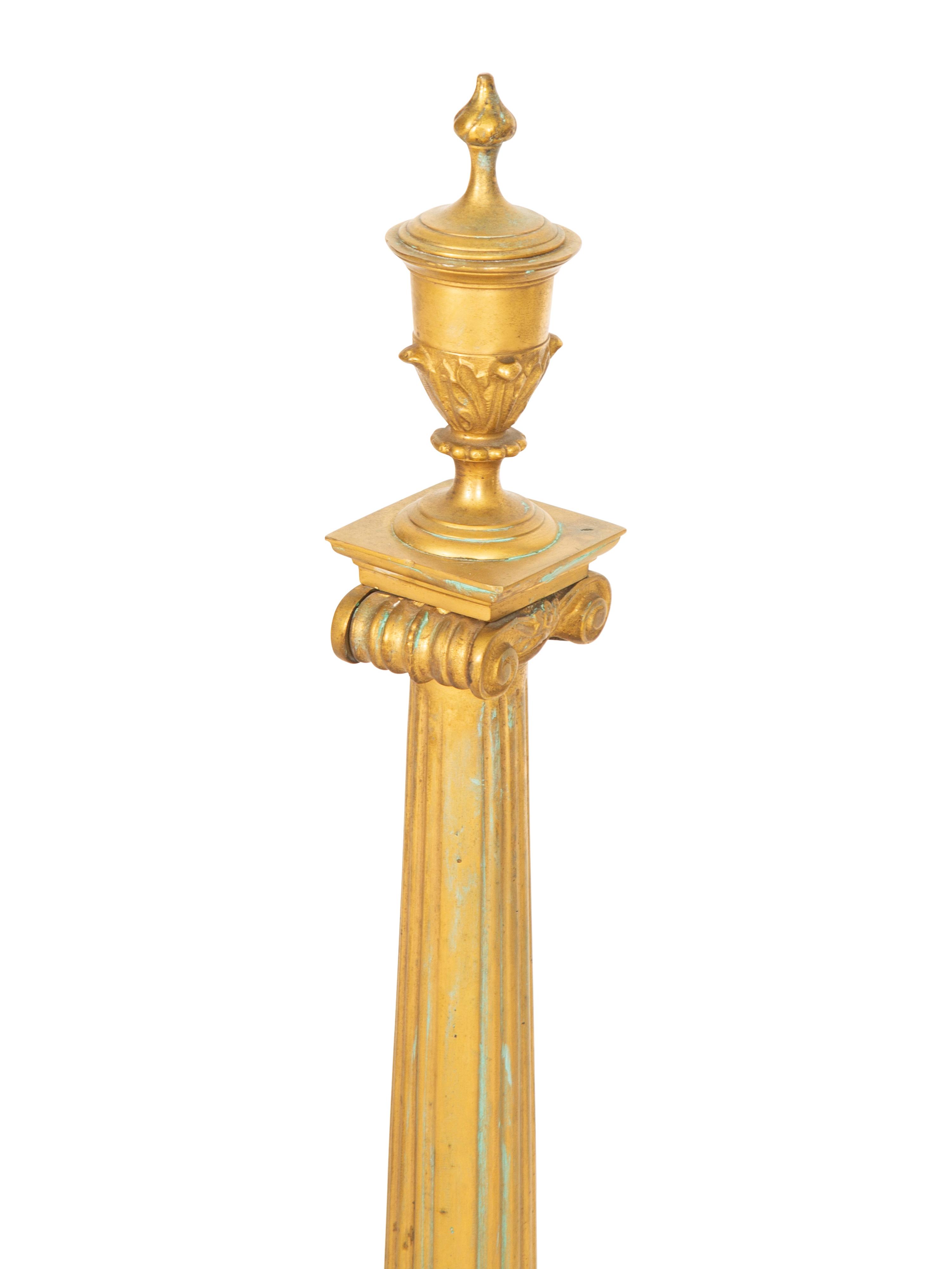A Pair of Continental Gilt Bronze Chenets and an Associated Fire Screen