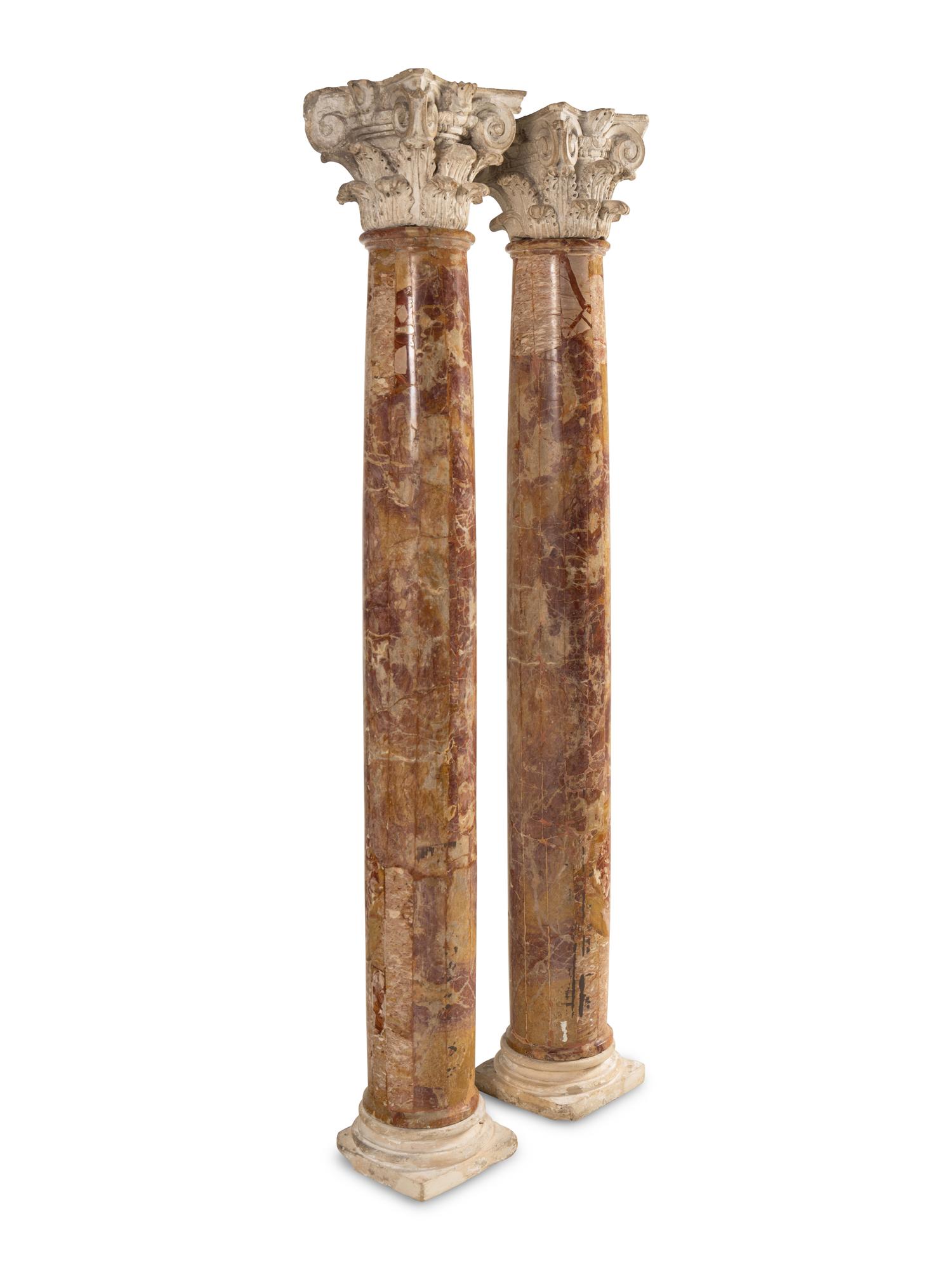 A Pair of Carved Limestone Capitals with Breccia Marble Columns