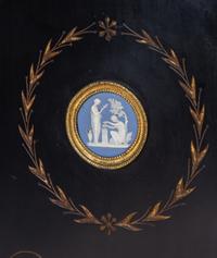 A Pair of English Aesthetic Jasperware Medallion-Mounted Ebonized and Parcel-Gilt Pedestal Cabinets
