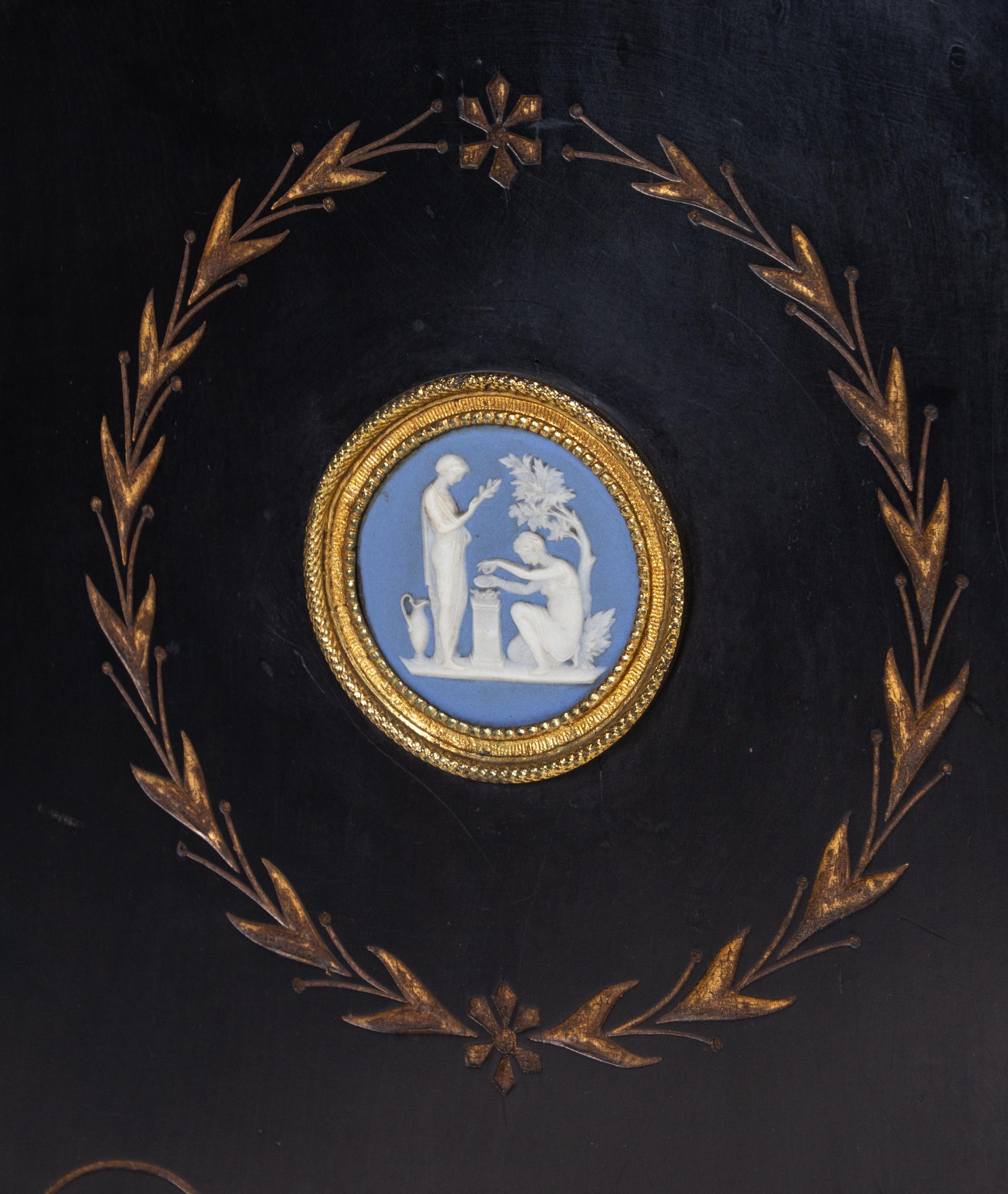A Pair of English Aesthetic Jasperware Medallion-Mounted Ebonized and Parcel-Gilt Pedestal Cabinets