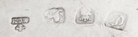 A Group of Silver Chambersticks, Various Makers, comprising a circular example engraved with a crest depicting a bird on rockery, Willi