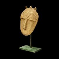 A Lagoons Region Gilt-Brass Mask Pendant