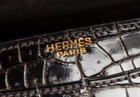 An Hermes Brown Crocodile Ring Handbag. 10" x 6.5" x 1.5".
