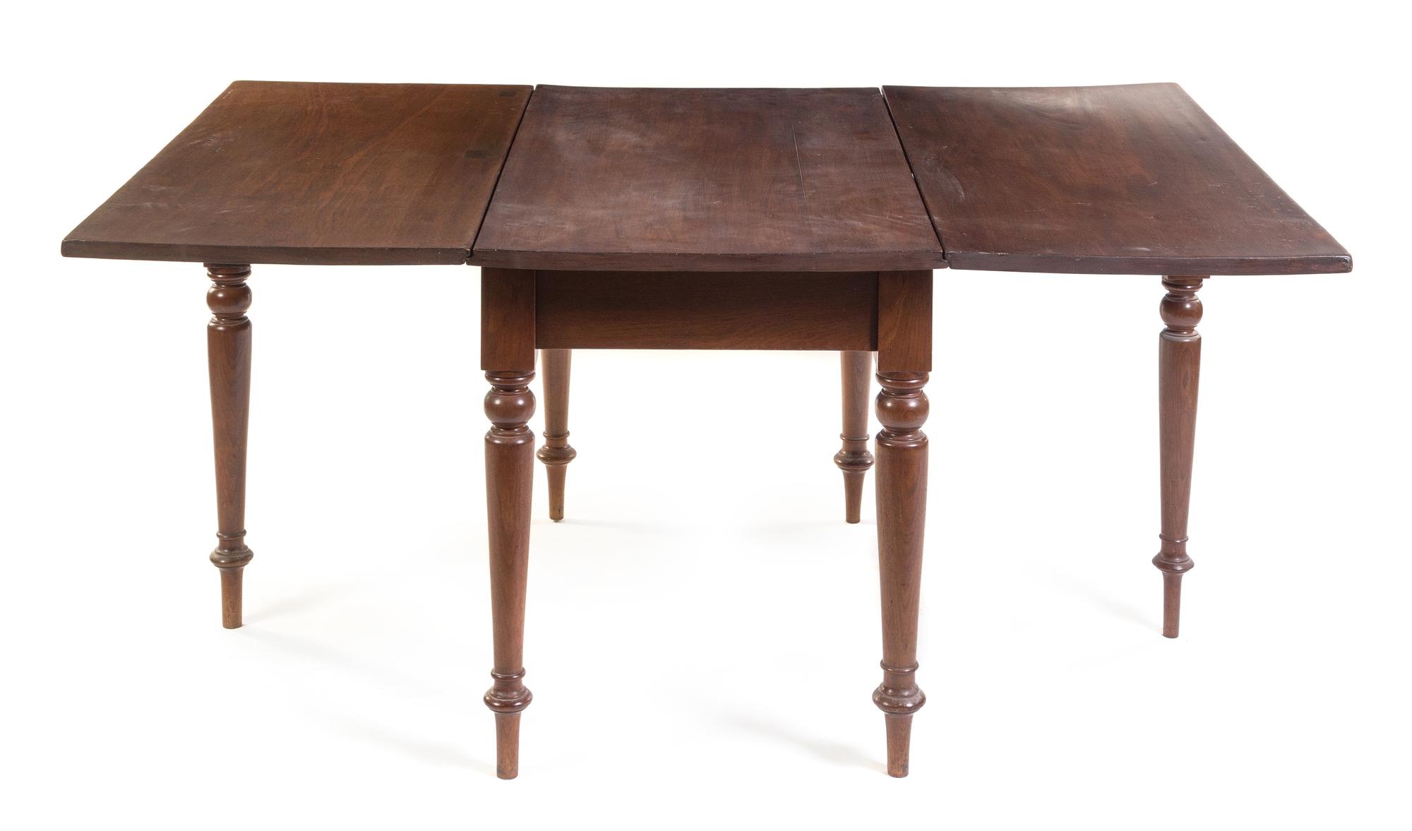 An American Cherry Drop Leaf Table Height 29 1/4 x width 46 x depth 25 1/2 inches (closed). — 19TH CENTURY