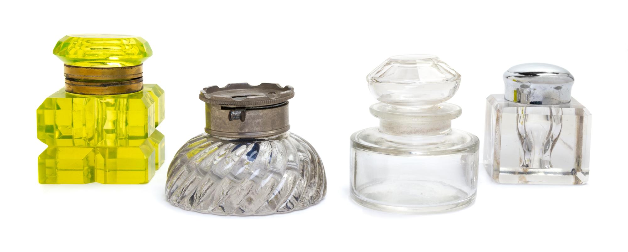 A Group of Four Glass Inkwells Height of tallest 3 inches.