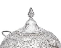 A George III sterling silver floral repoussé hot water urn, maker's mark rubbed, London, 1766