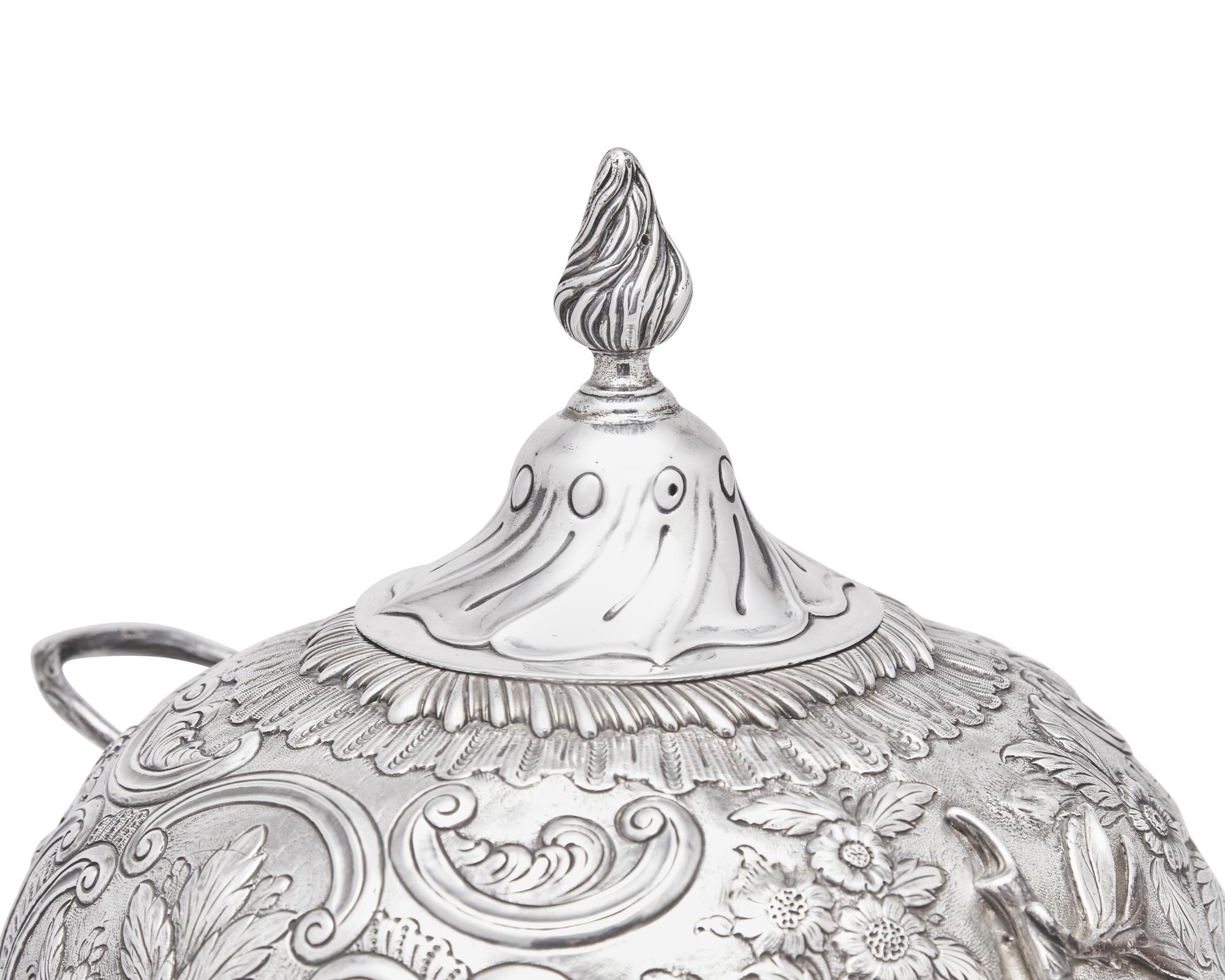 A George III sterling silver floral repoussé hot water urn, maker's mark rubbed, London, 1766