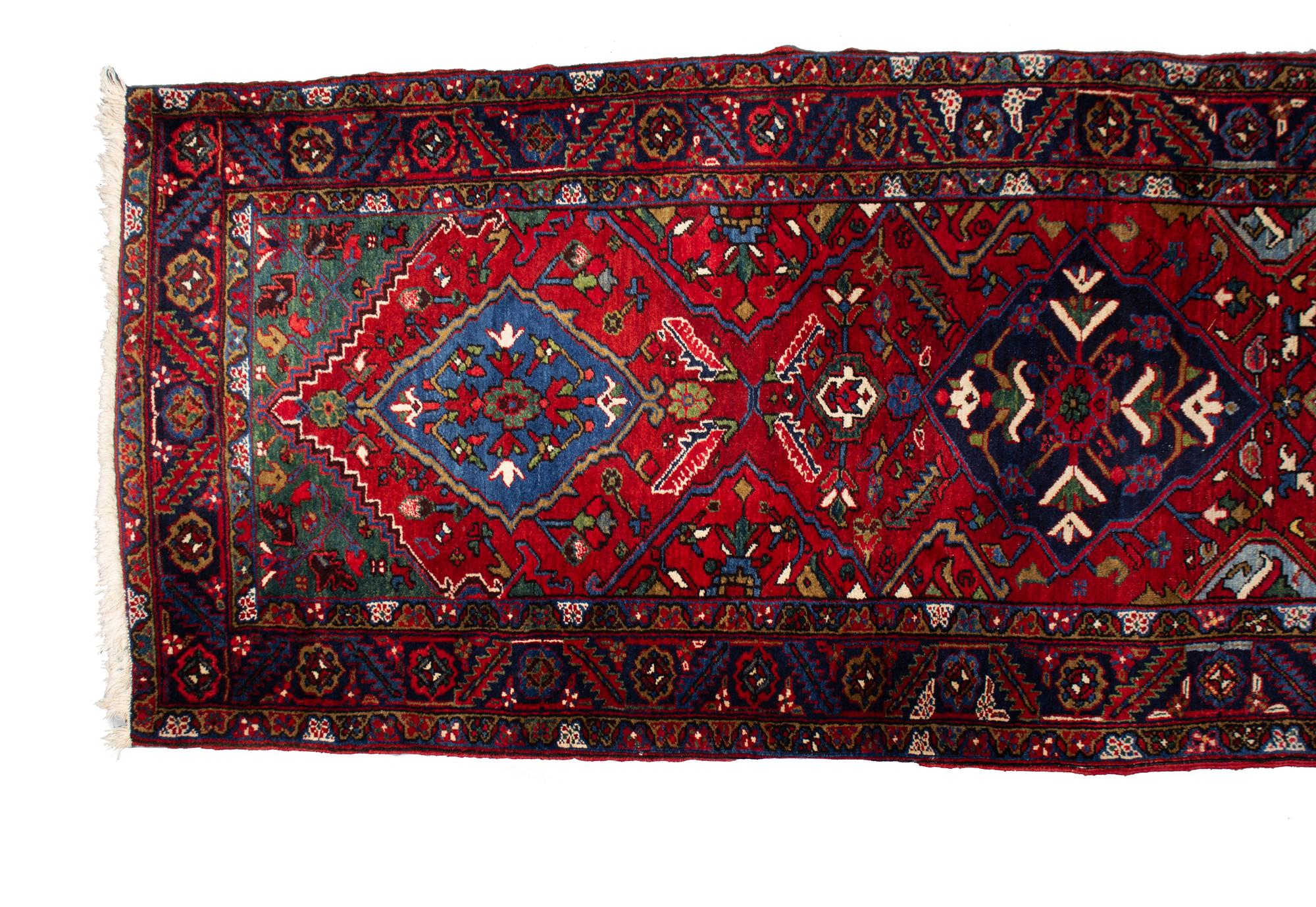 A Persian Wool Runner 19 feet 2 inches x 3 feet 5 inches. — 20TH CENTURY