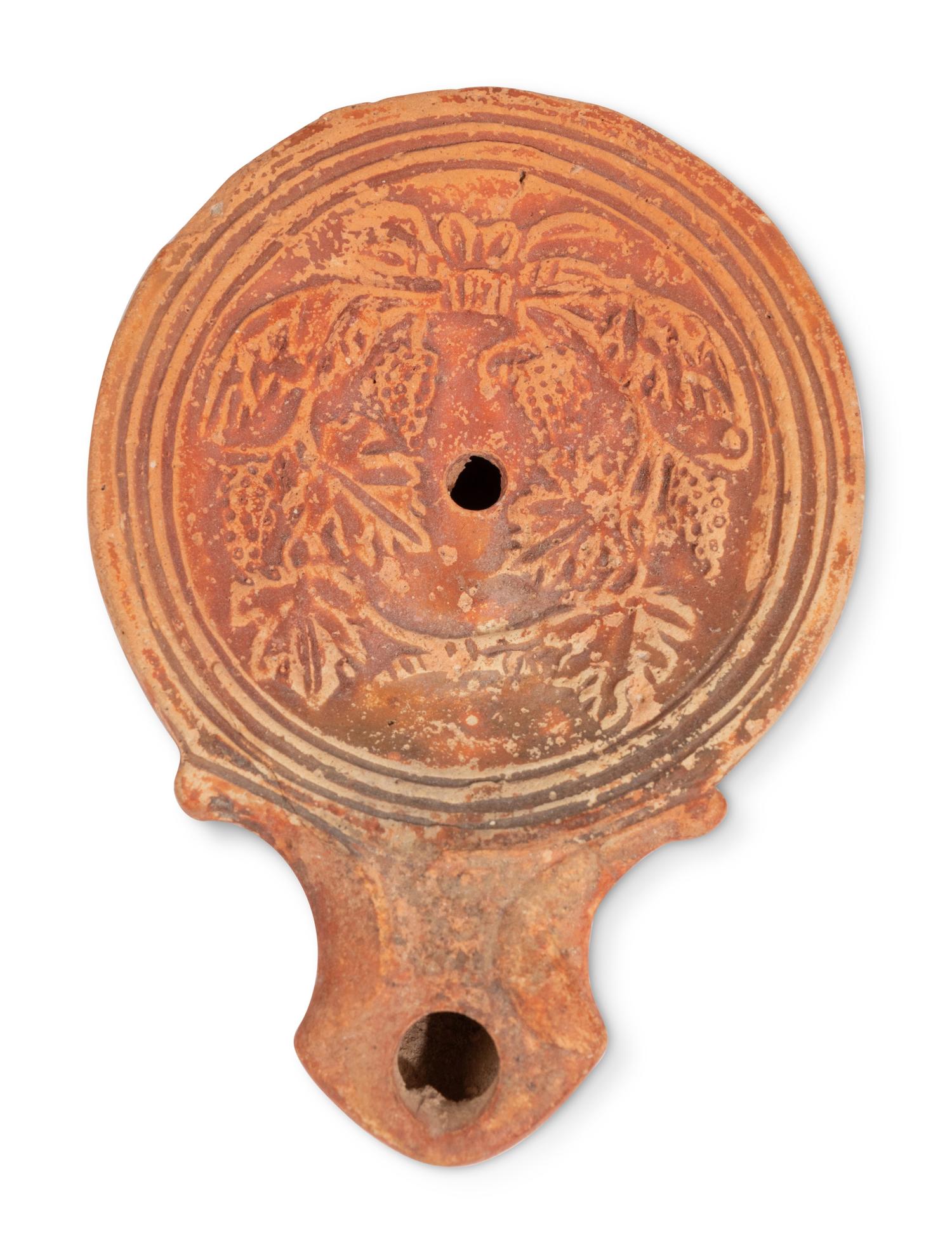 Ten Roman Terracotta Oil Lamps and a Holy Land Pottery Jug