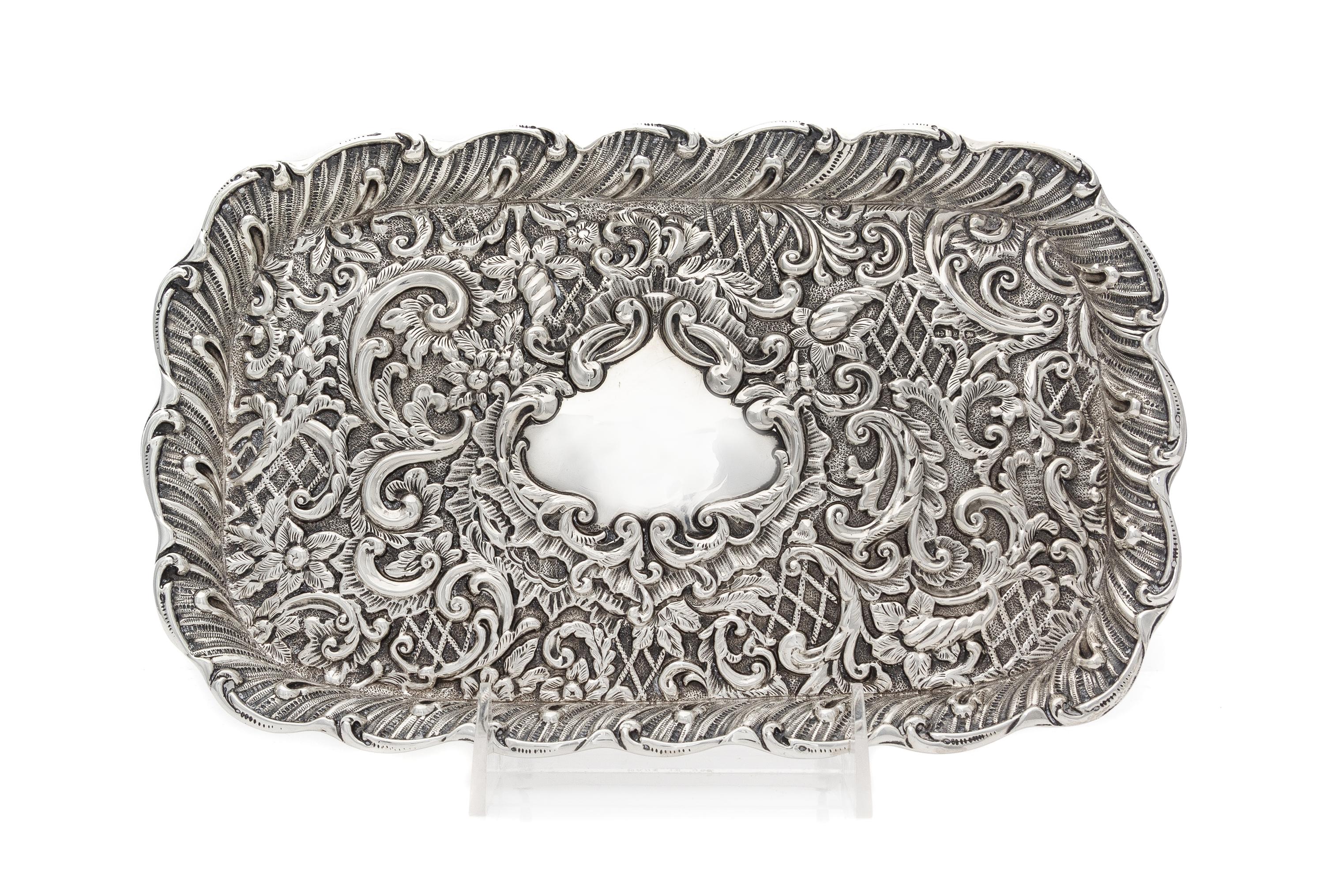 A Victorian Silver Tray, H. Matthews, Birmingham, 1898, of rectangular form with allover rococo decoration, centered by a vacant cartou