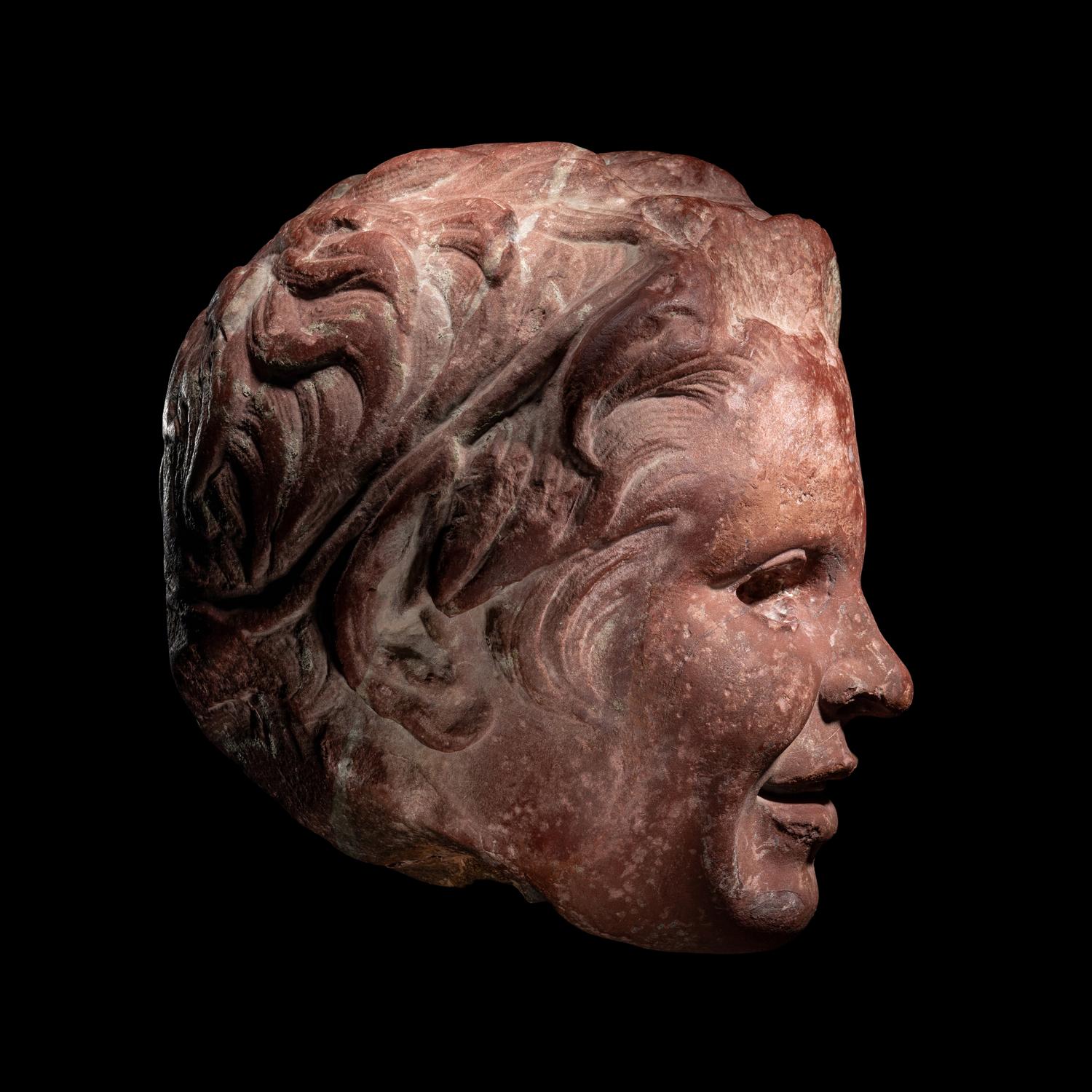 A Roman Rosso Antico Head of a Young Satyr