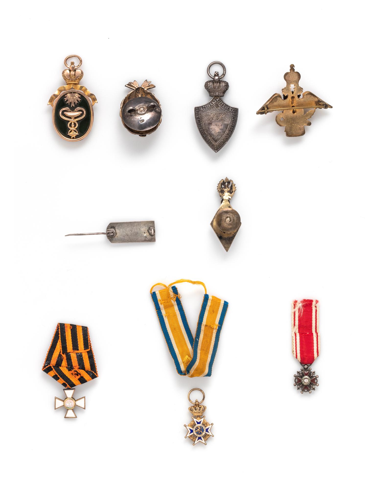 A Group of Nine Silver, Gold and Enamel Orders of Merit and Badges