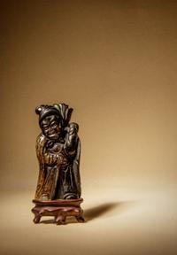 A Black and Grey Jade Figure of a Foreigner