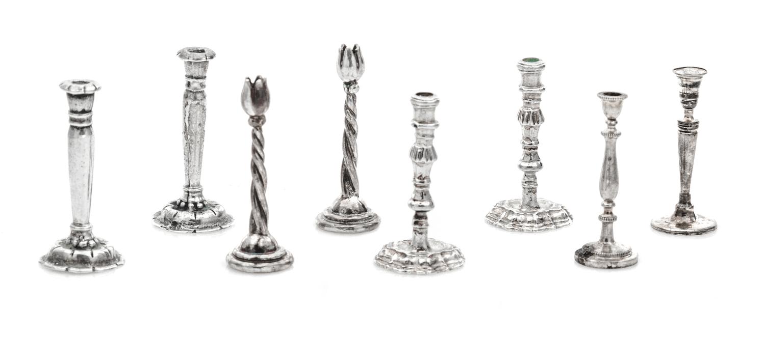 Four Pairs of Silver Candelabra, Various Makers, comprising a pair with tulip-form cups and a twisted stem; a pair having baluster form