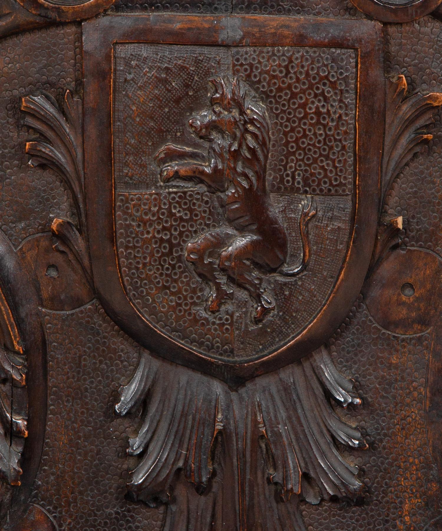 A Jacobean Style Carved Oak Bench with Armorial and Lion Carved Back