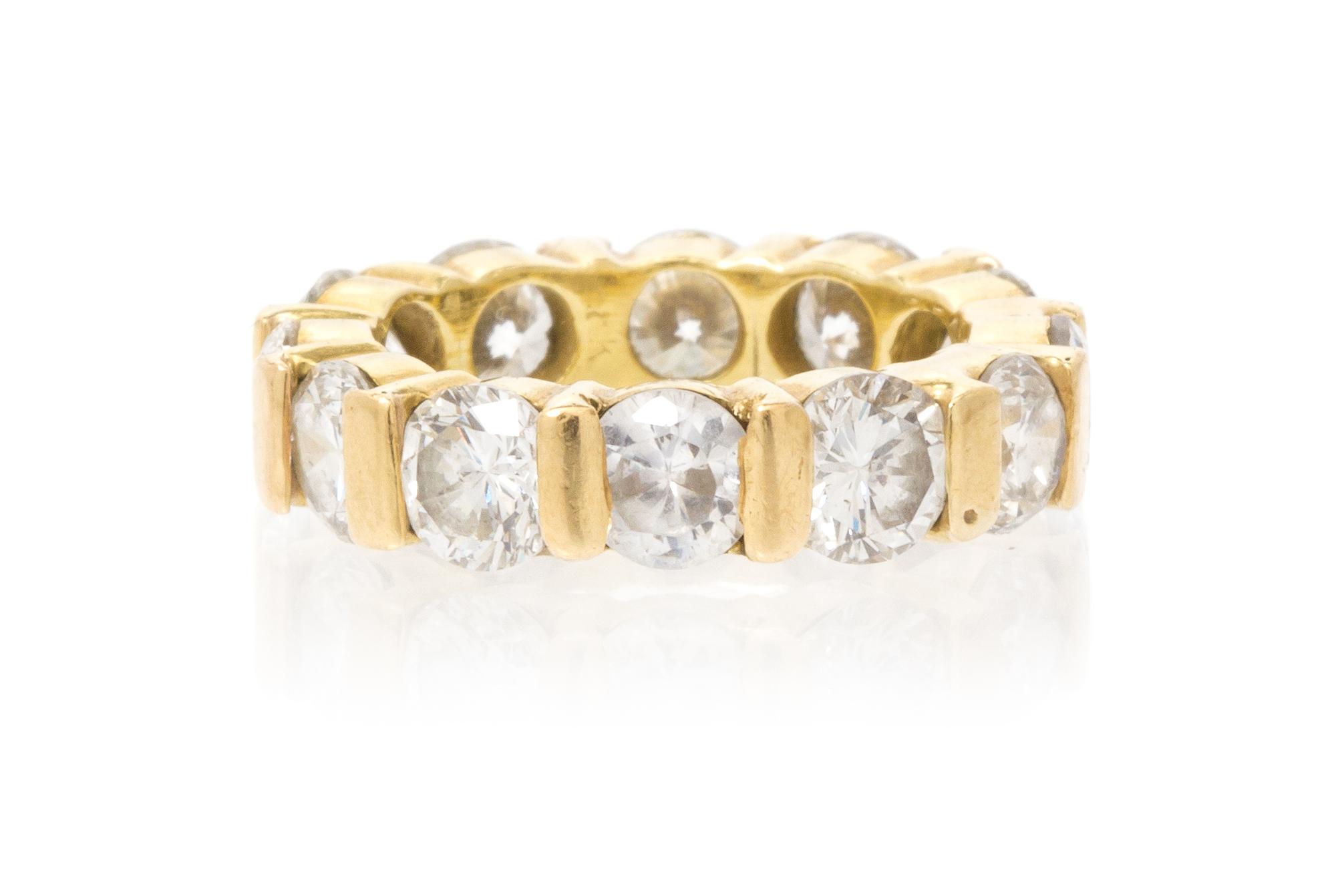 A Yellow Gold, Diamond and Simulated Diamond Eternity Band, 5.50 dwts.