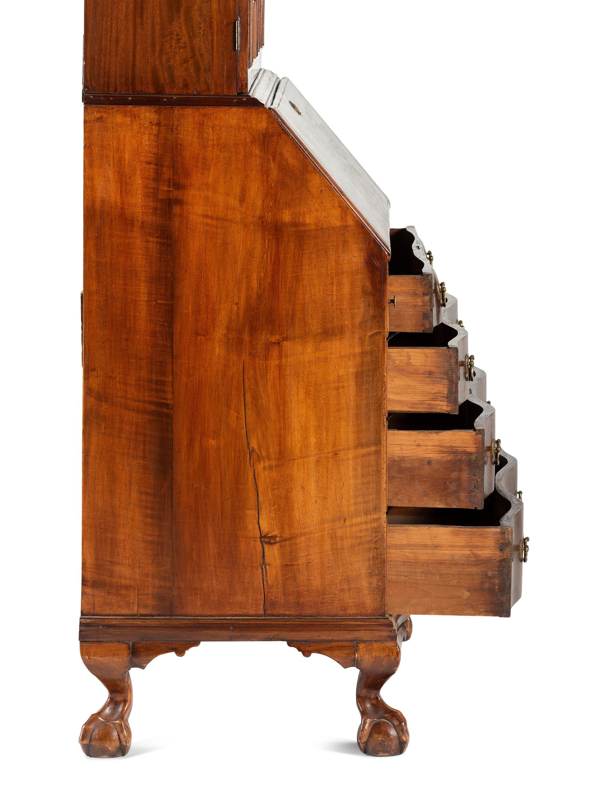 A Chippendale Mahogany and Cherrywood Serpentine Claw-and-Ball Foot Desk-and-Bookcase