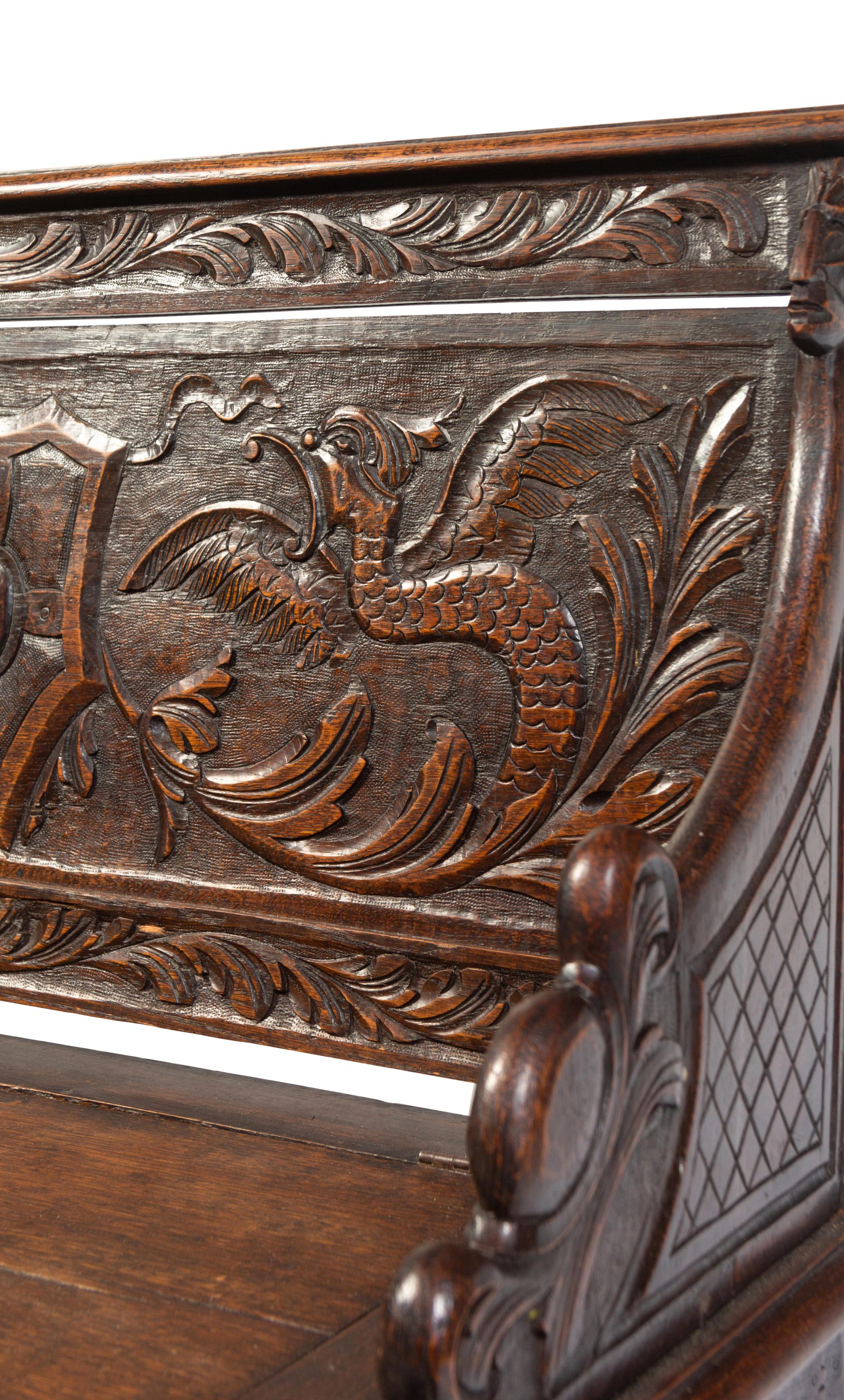 An Italian Renaissance Revival Carved Oak Settle