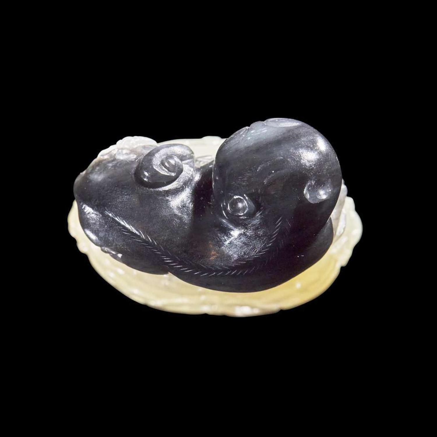 A Chinese carved two-color jade "Cat and Butterfly on Garden Stool" toggle “貓蝶”俏色玉雕一件