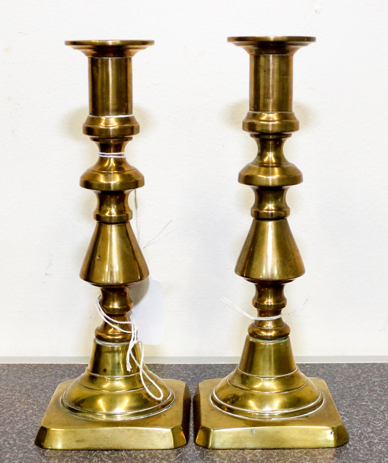 A Pair of Brass Candlesticks Height 8 inches.