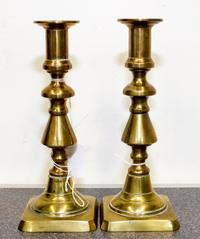 A Pair of Brass Candlesticks Height 8 inches.
