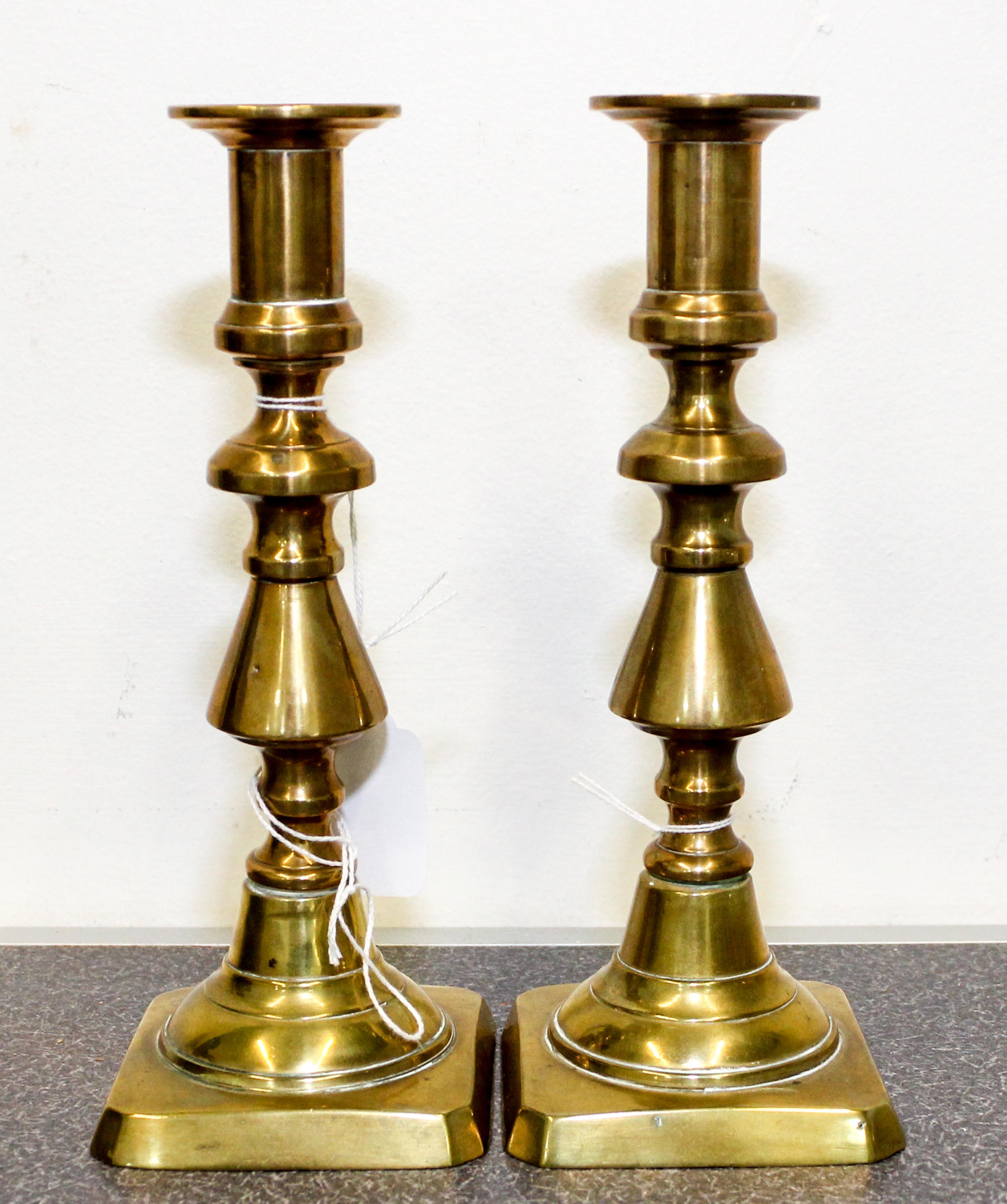 A Pair of Brass Candlesticks Height 8 inches.