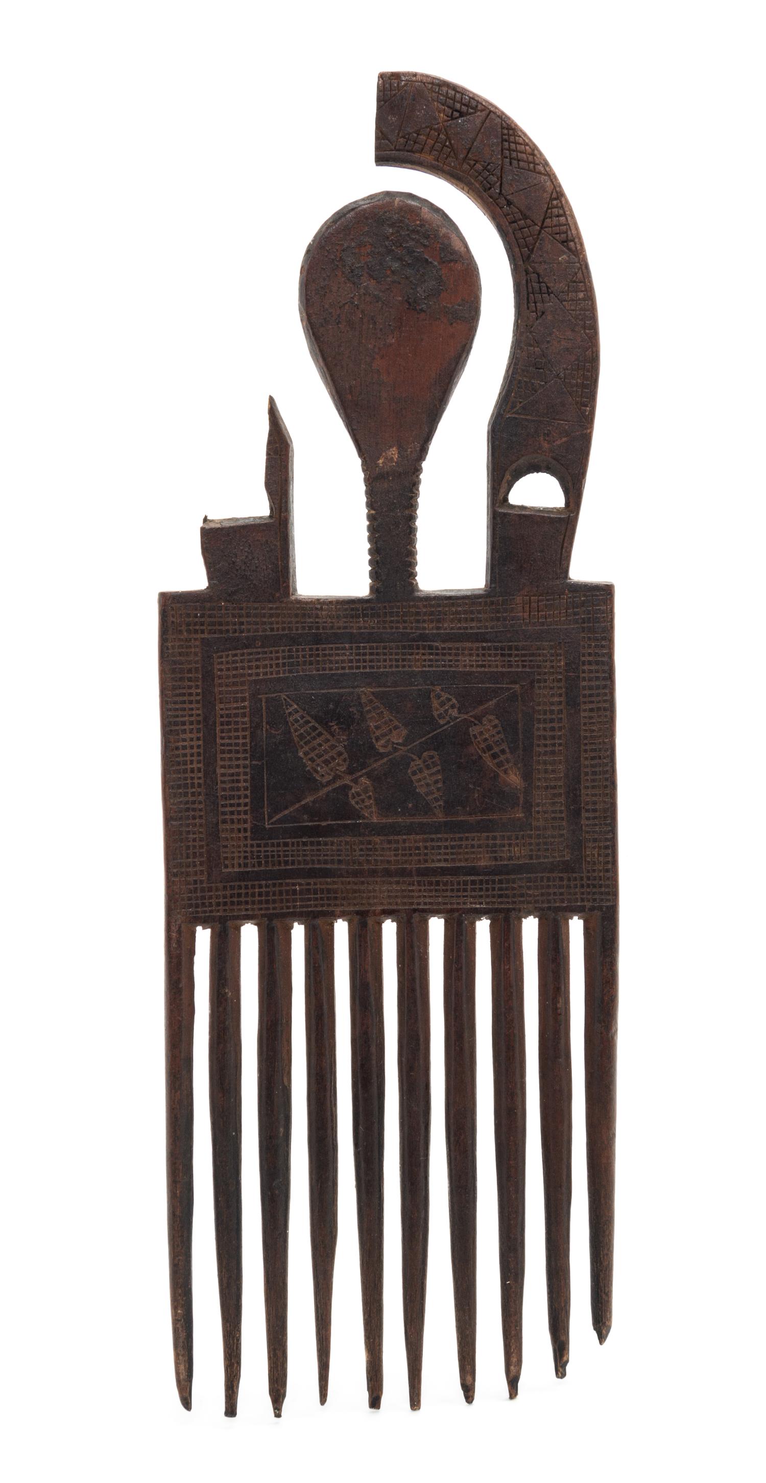 An Ashanti Carved Wood Comb. Height 9 x width 3 1/4 x depth 1/4 inches.