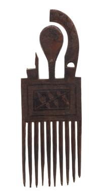 An Ashanti Carved Wood Comb. Height 9 x width 3 1/4 x depth 1/4 inches.