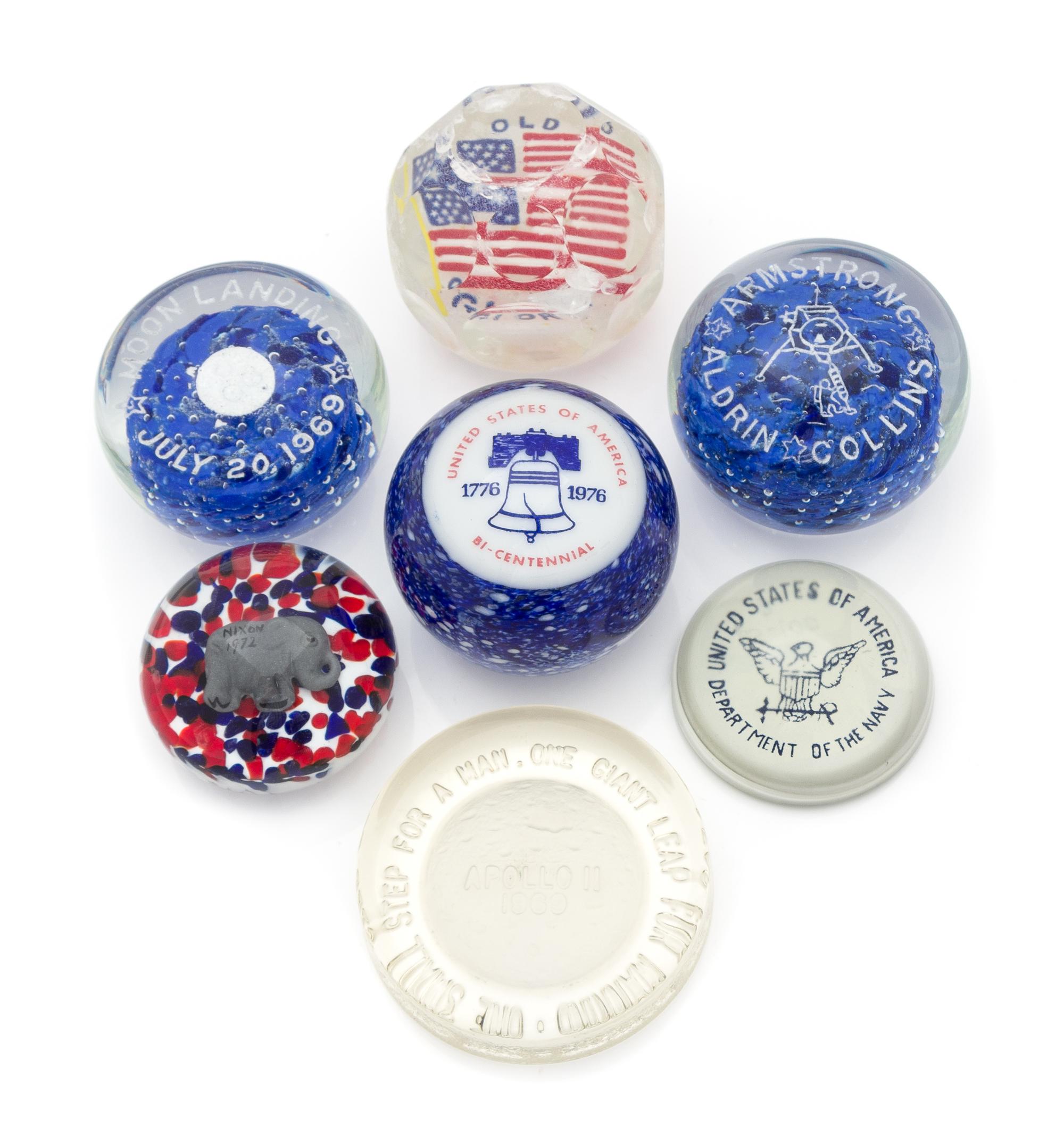 A Group of Seven American Commemorative Glass Paperweights Diameter of largest 3 1/2 inches