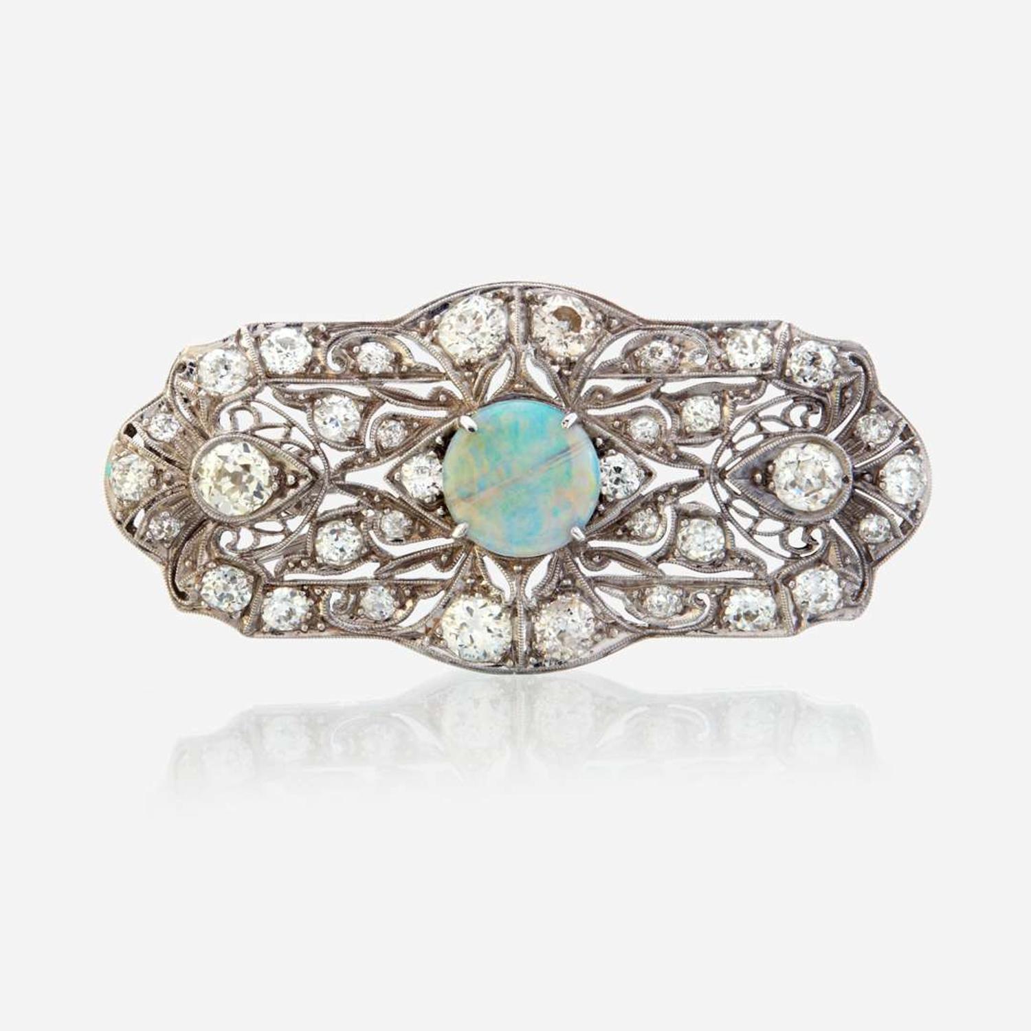An opal, diamond, and platinum pendant/brooch