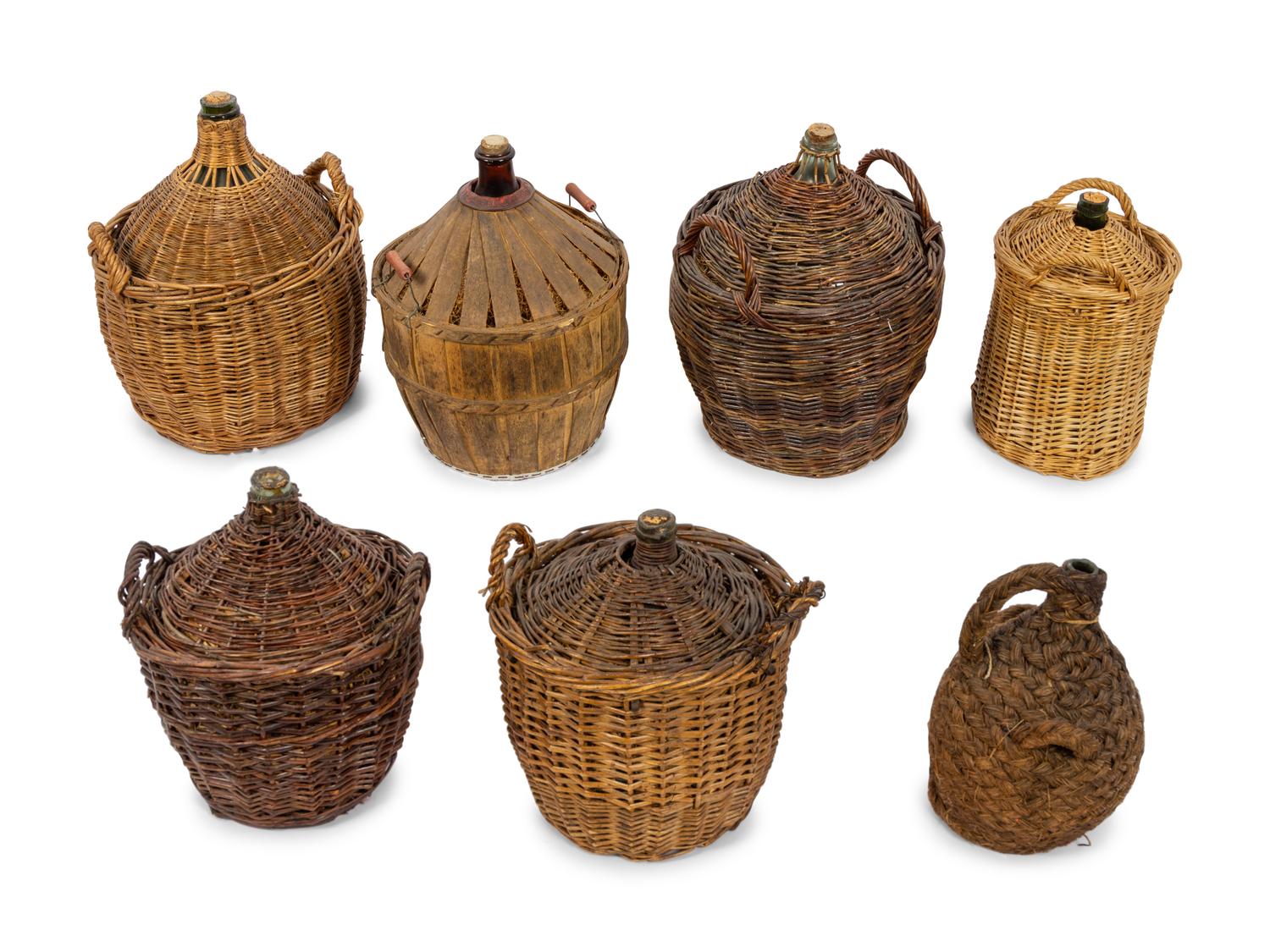 A Group of Seven Continental Rattan and Glass Wine Jugs