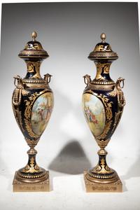 A Pair of Monumental Sèvres Style Gilt Metal Mounted Porcelain Covered Urns on Pedestals