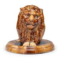 A Yellowware Recumbent Lion Figure