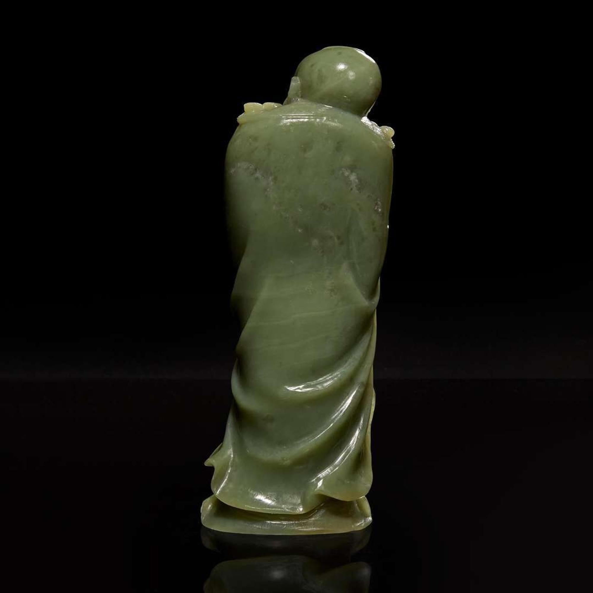 A Chinese carved celadon jade figure of a Lohan 青玉雕羅漢