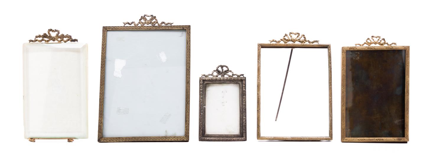 A Collection of Five Cast Metal Frames Height of largest overall 9 inches.