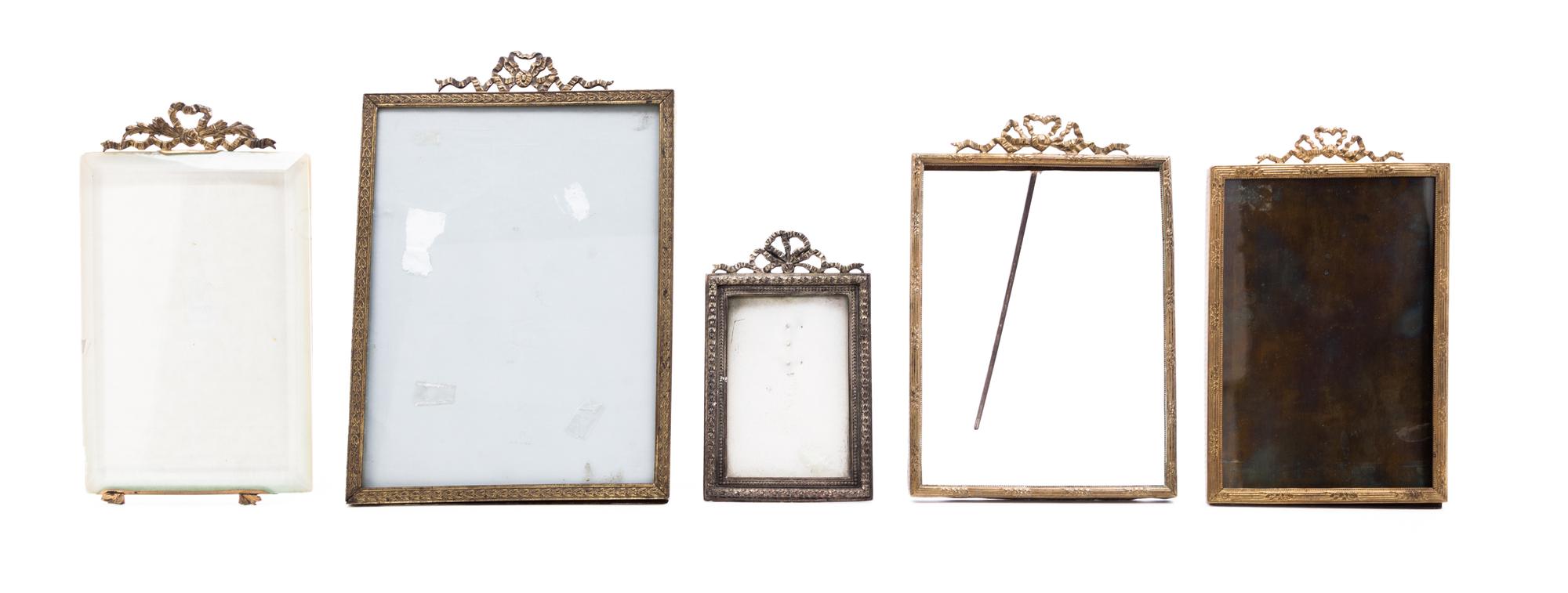 A Collection of Five Cast Metal Frames Height of largest overall 9 inches.