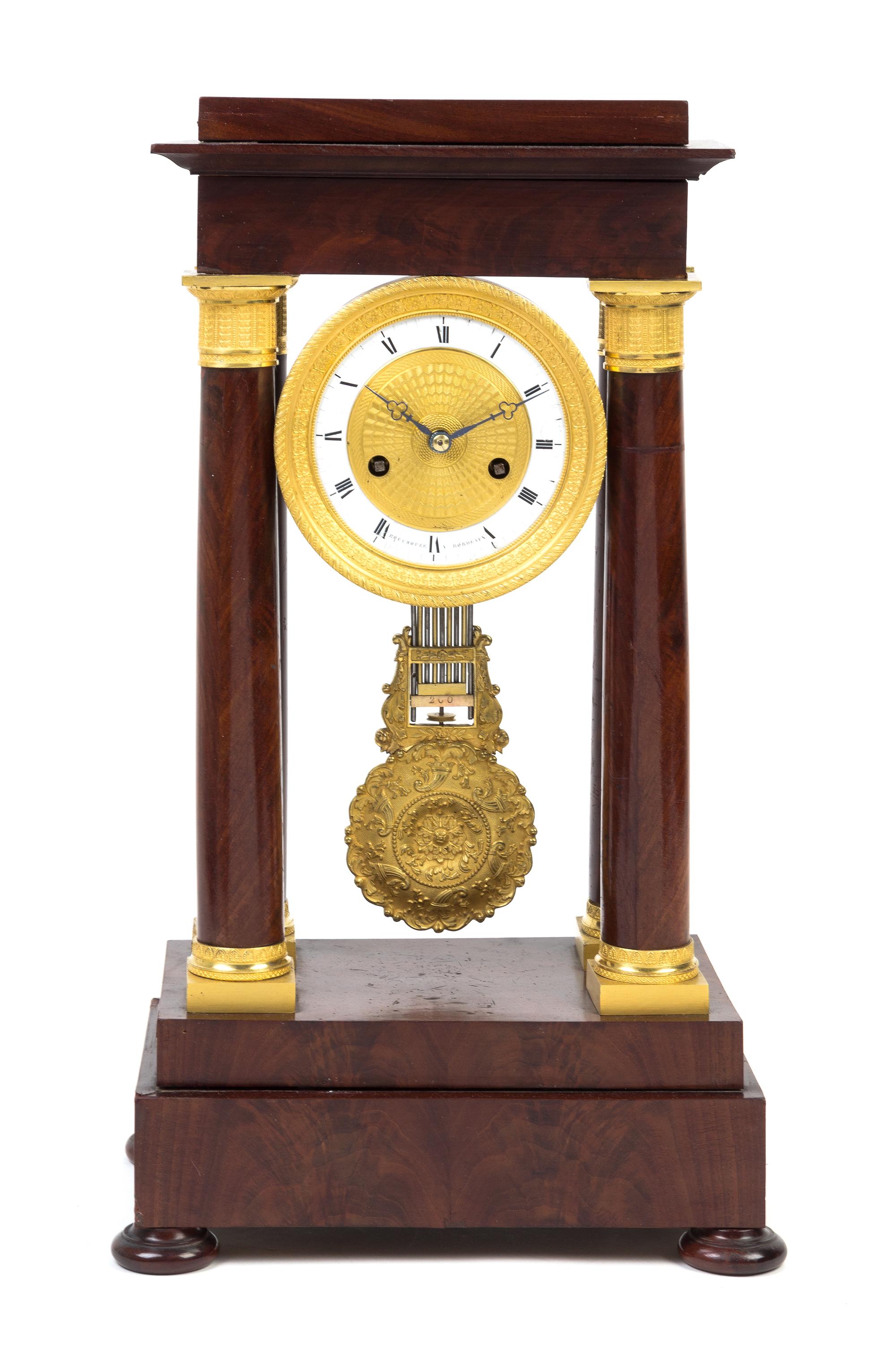 An Empire Gilt Metal Mounted Mahogany Portico Clock Height 18 5/8 inches. — 19TH CENTURY