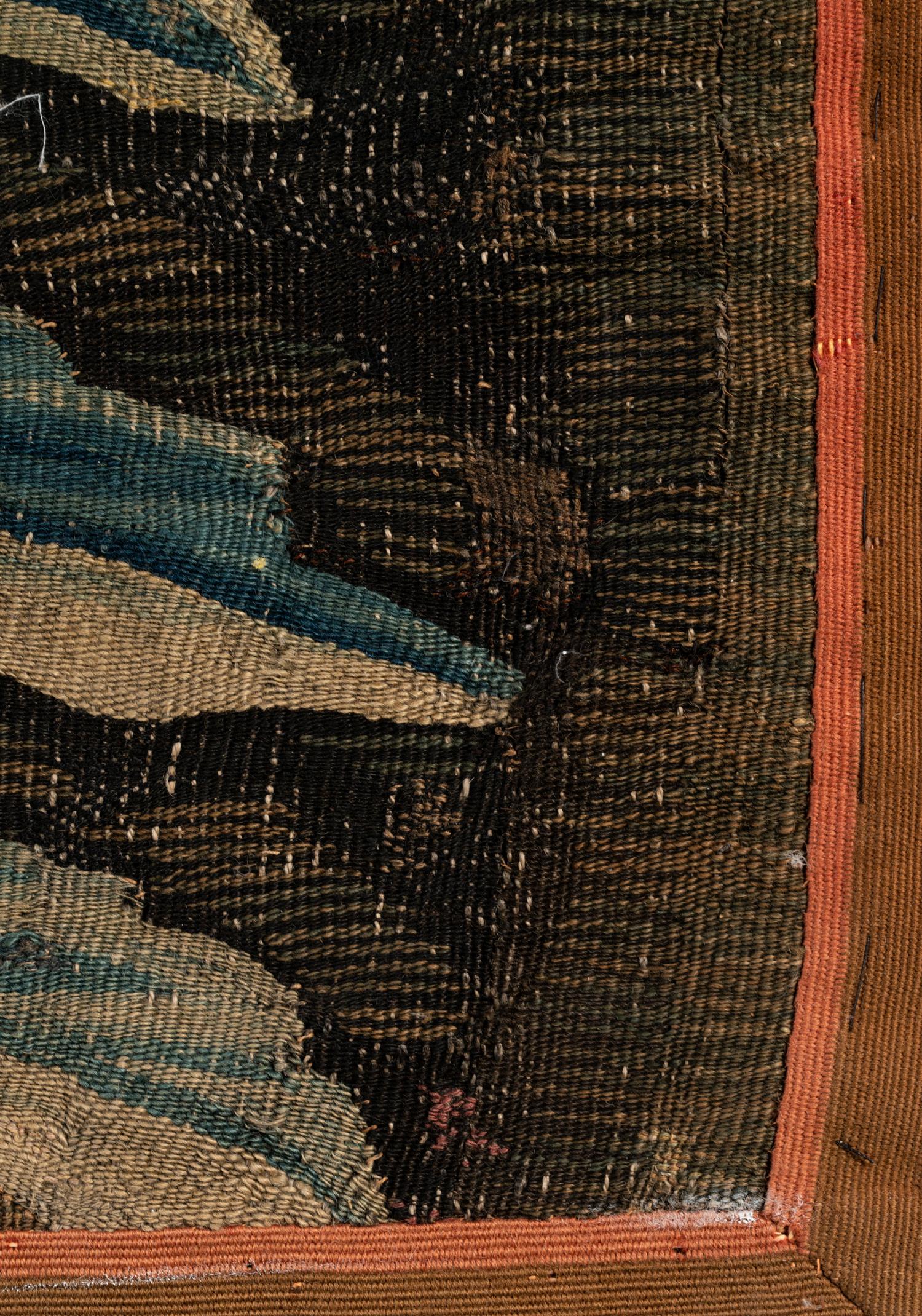 A Continental Wool Verdure Tapestry Fragment