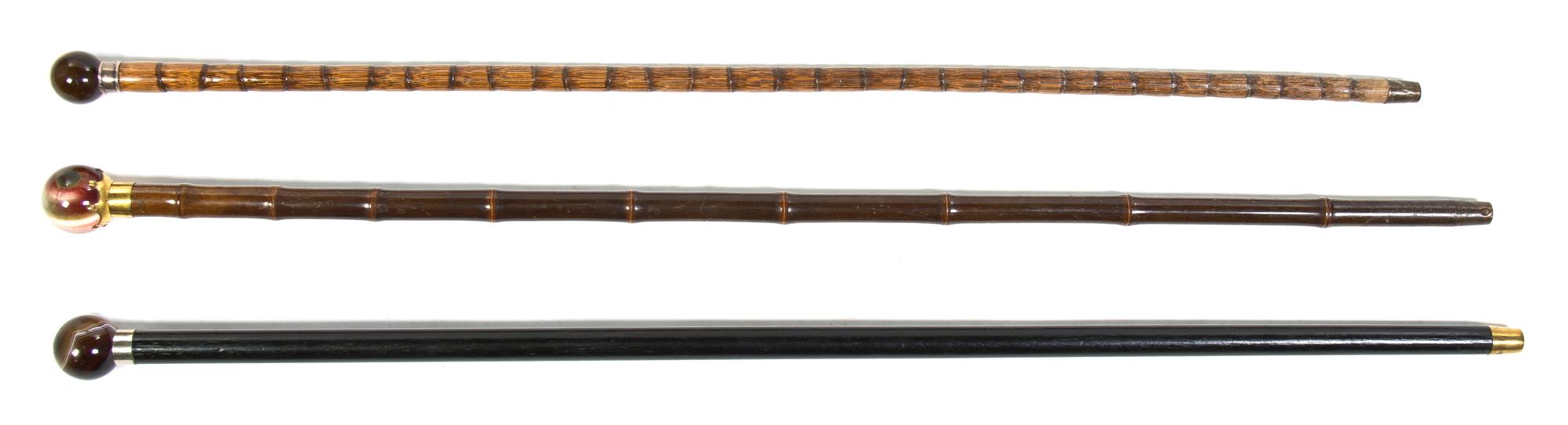 Three Hardstone Mounted Walking Sticks, Height of tallest overall 36 3/8 inches.