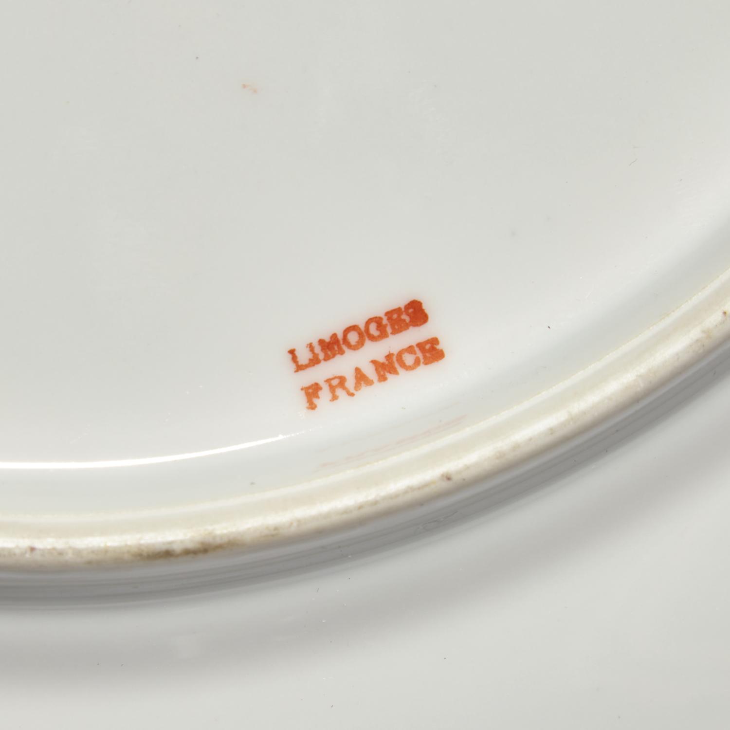 A Set of Twelve Limoges Porcelain Chargers