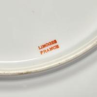 A Set of Twelve Limoges Porcelain Chargers