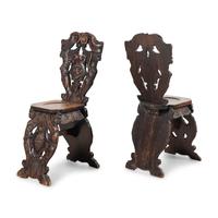 A Pair of Italian Carved Walnut Sgabello Chairs