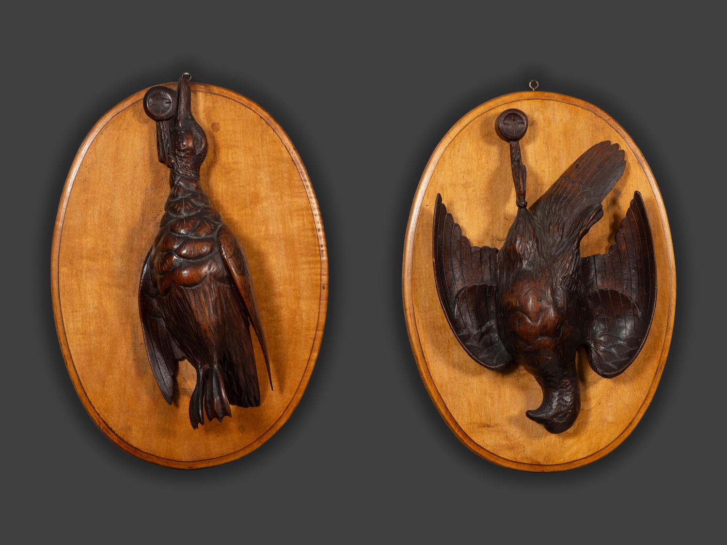 A Pair of Black Forest Style Carved Wood Game Plaques