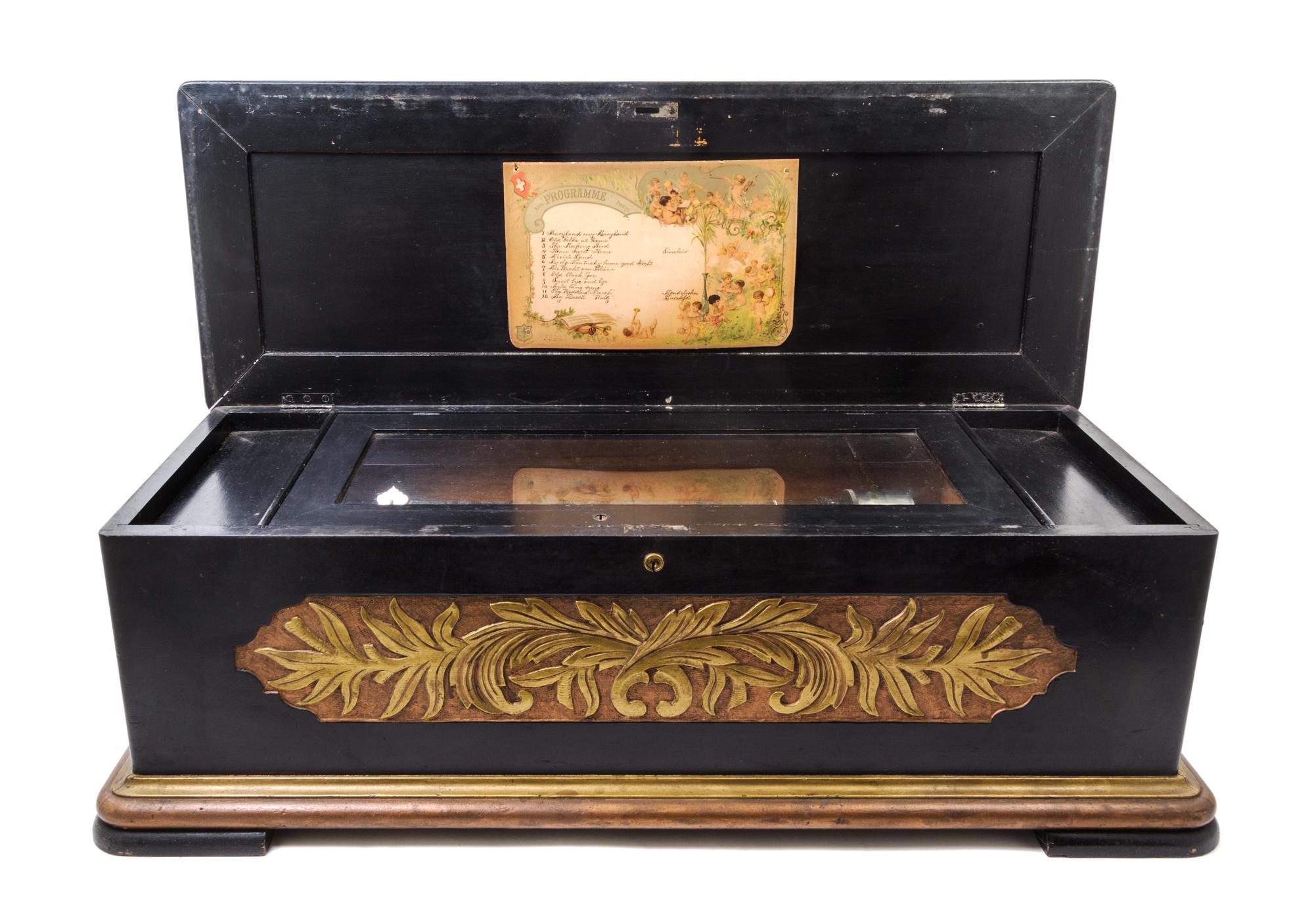 A Continental Cylinder Music Box Height of case 12 x width 37 x depth 14 inches.