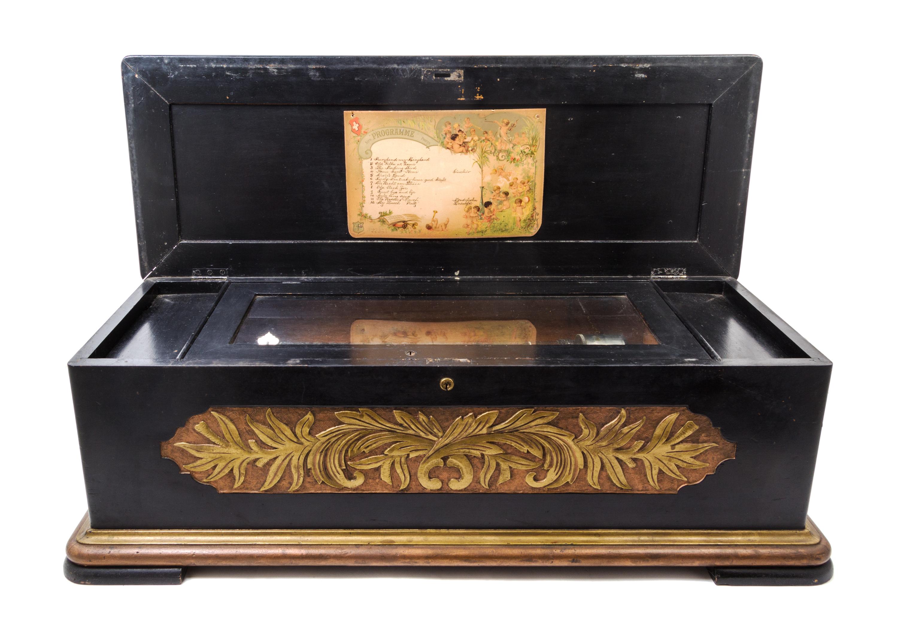 A Continental Cylinder Music Box Height of case 12 x width 37 x depth 14 inches.