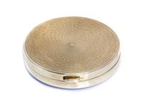 An Edwardian Silver and Enamel Box, Crisford & Norris, Birmingham, 1909, of circular form, the lid with blue guilloche enamel and openi