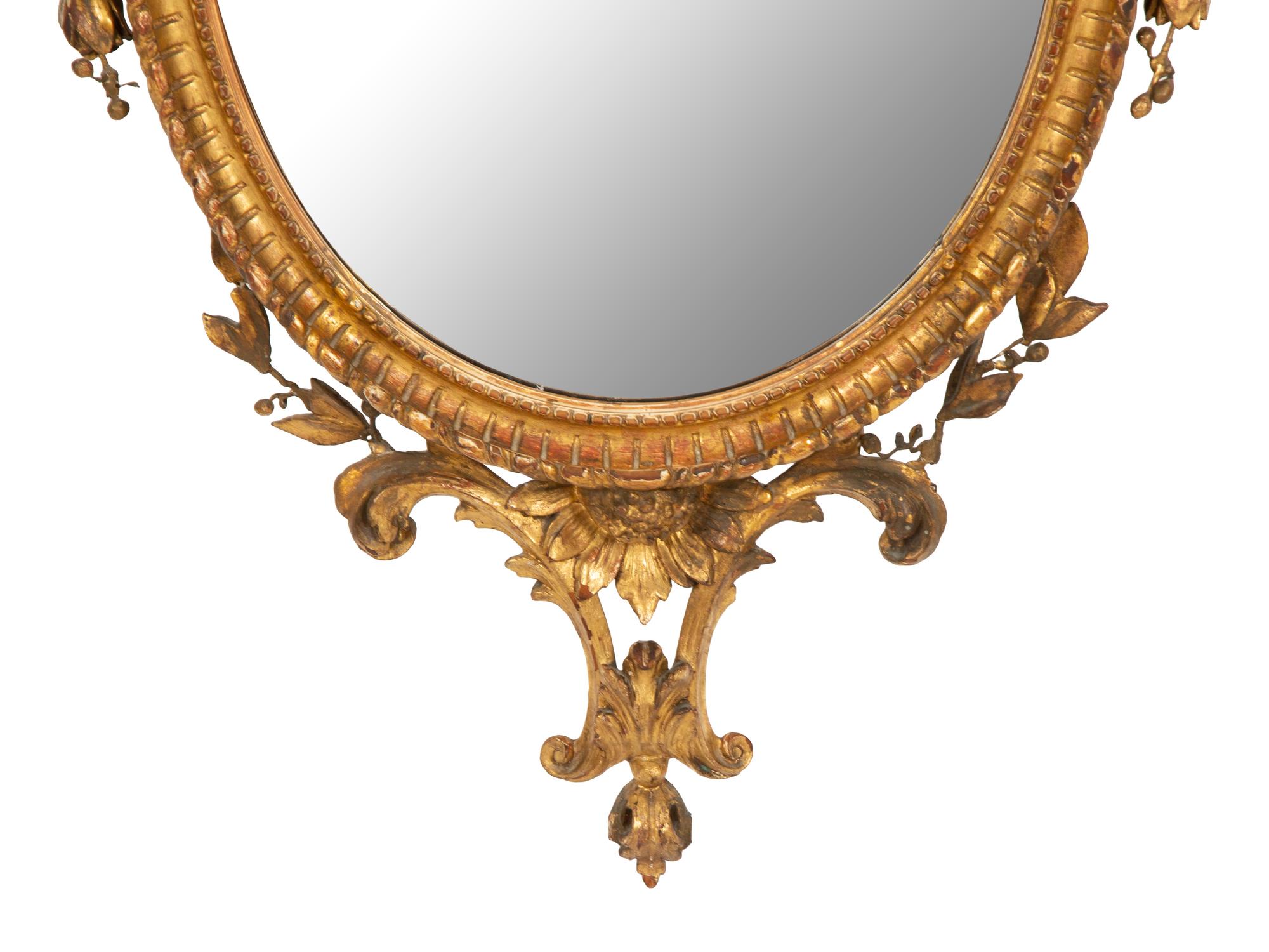 A Neoclassical Style Giltwood Oval Mirror