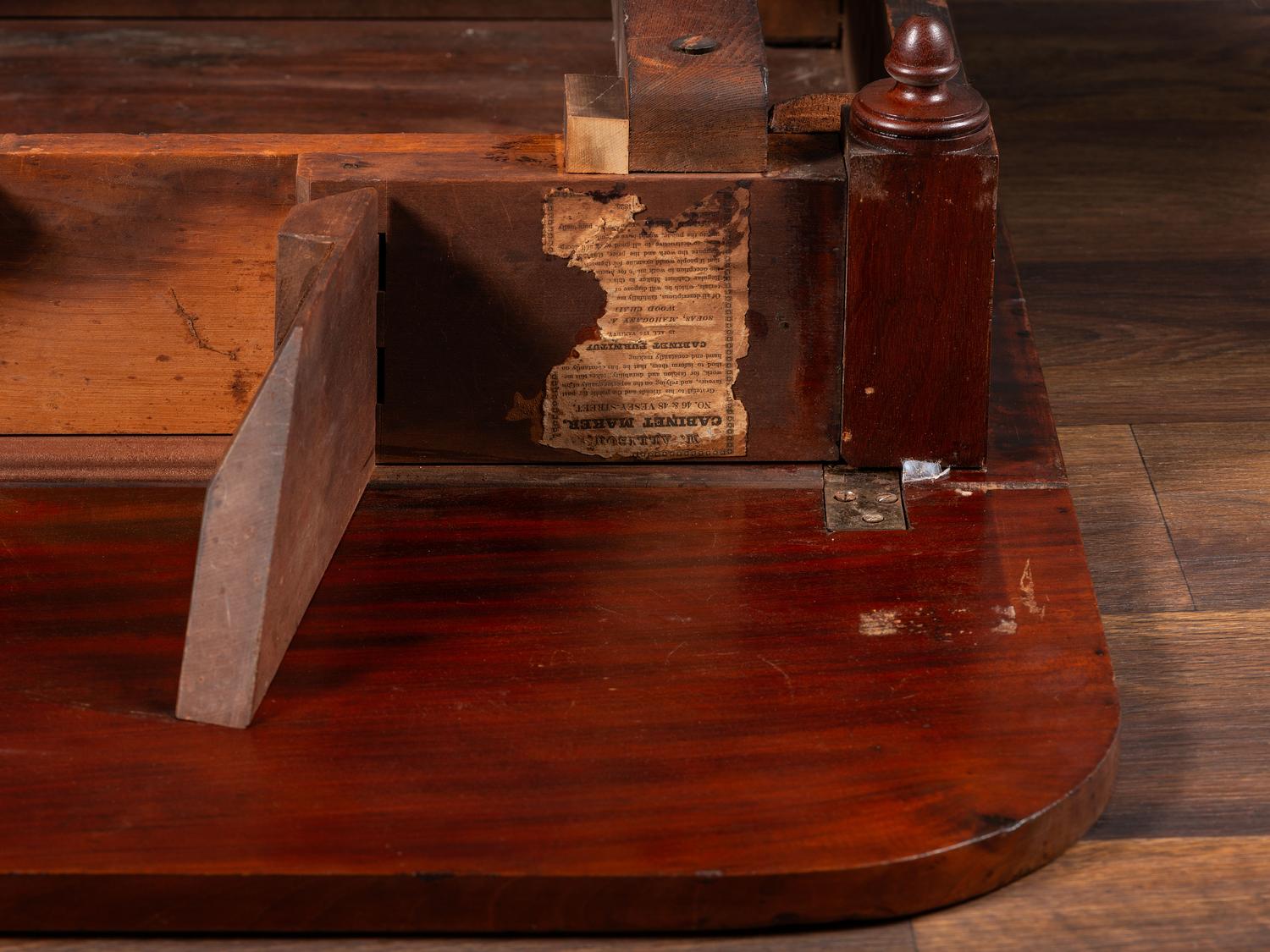 A Classical Parcel Gilt and Ebonized, Figured Mahogany Paw-Foot Drop-Leaf Table